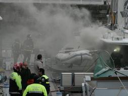 Los bomberos sofocan el incendio en el puerto deportivo de Fomento. FOTO: LUIS SEVILLA/
