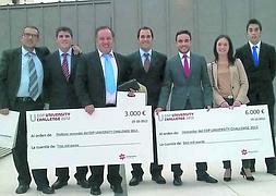 Profesores y alumnos posan con los cheques de ganadores. :: E. C./