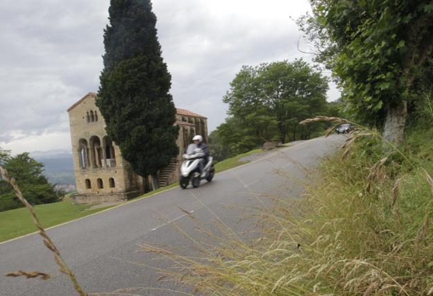 Un motorista circula ante el monumento prerrománico de Santa María del Naranco. / MARIO ROJAS